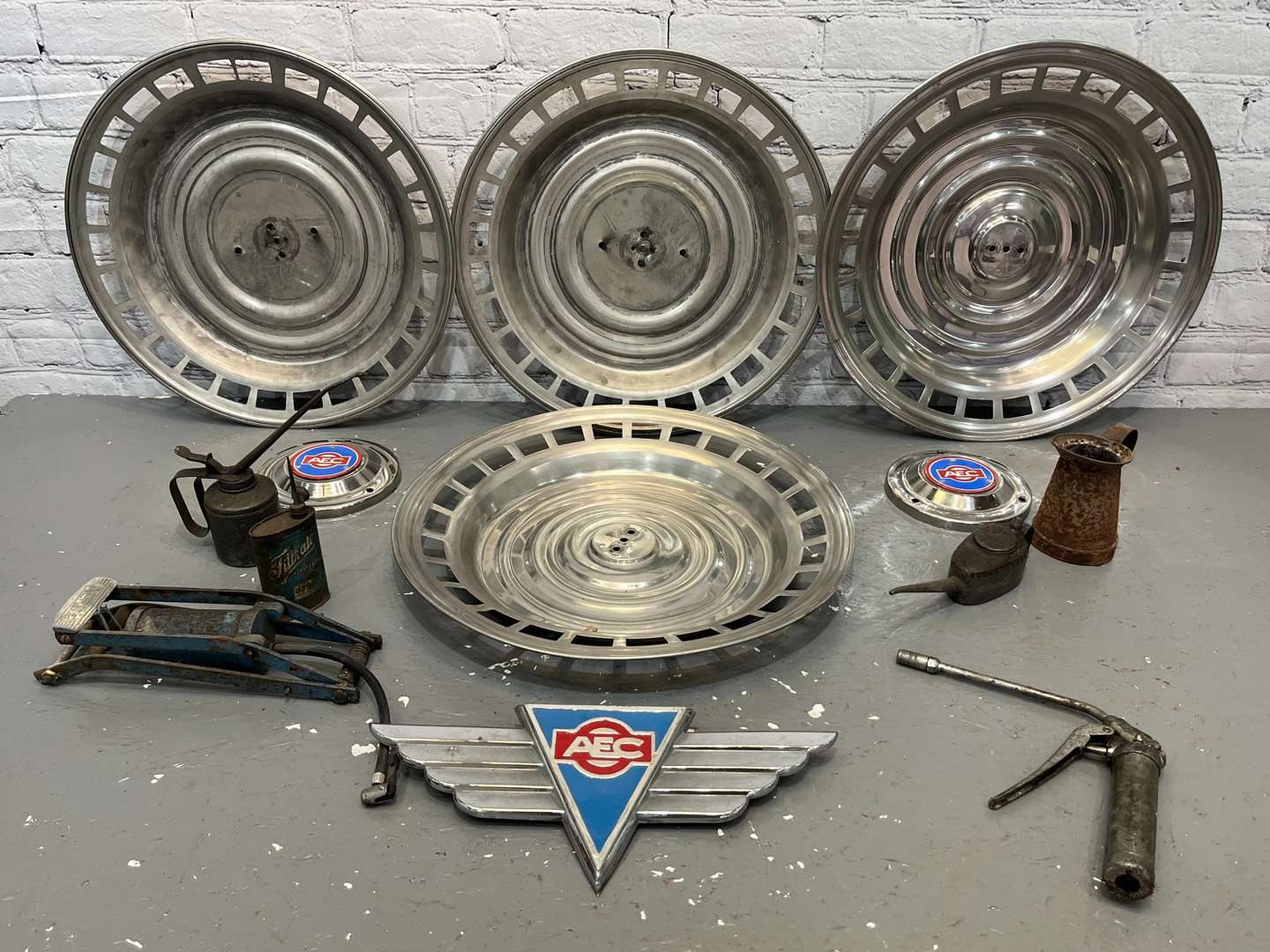 <p>AEC Badges, Four Commercial Hub Caps, Oil cans Etc</p>