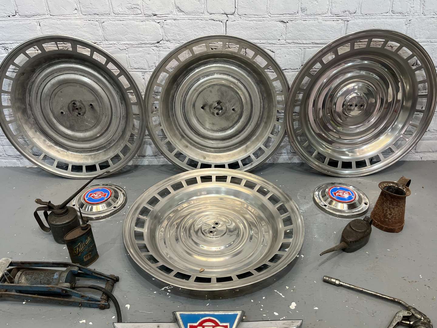 <p>AEC Badges, Four Commercial Hub Caps, Oil cans Etc</p>