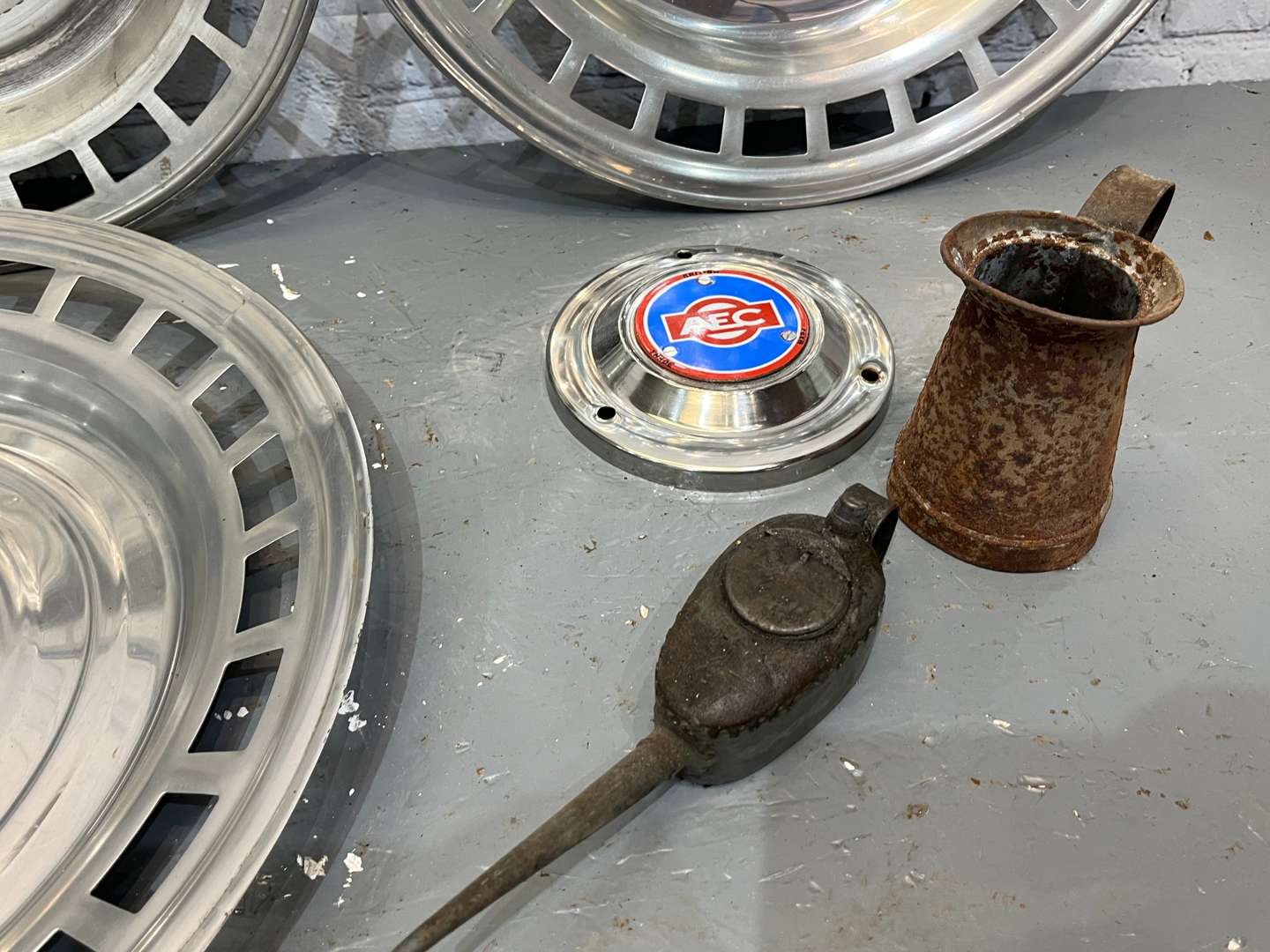 <p>AEC Badges, Four Commercial Hub Caps, Oil cans Etc</p>