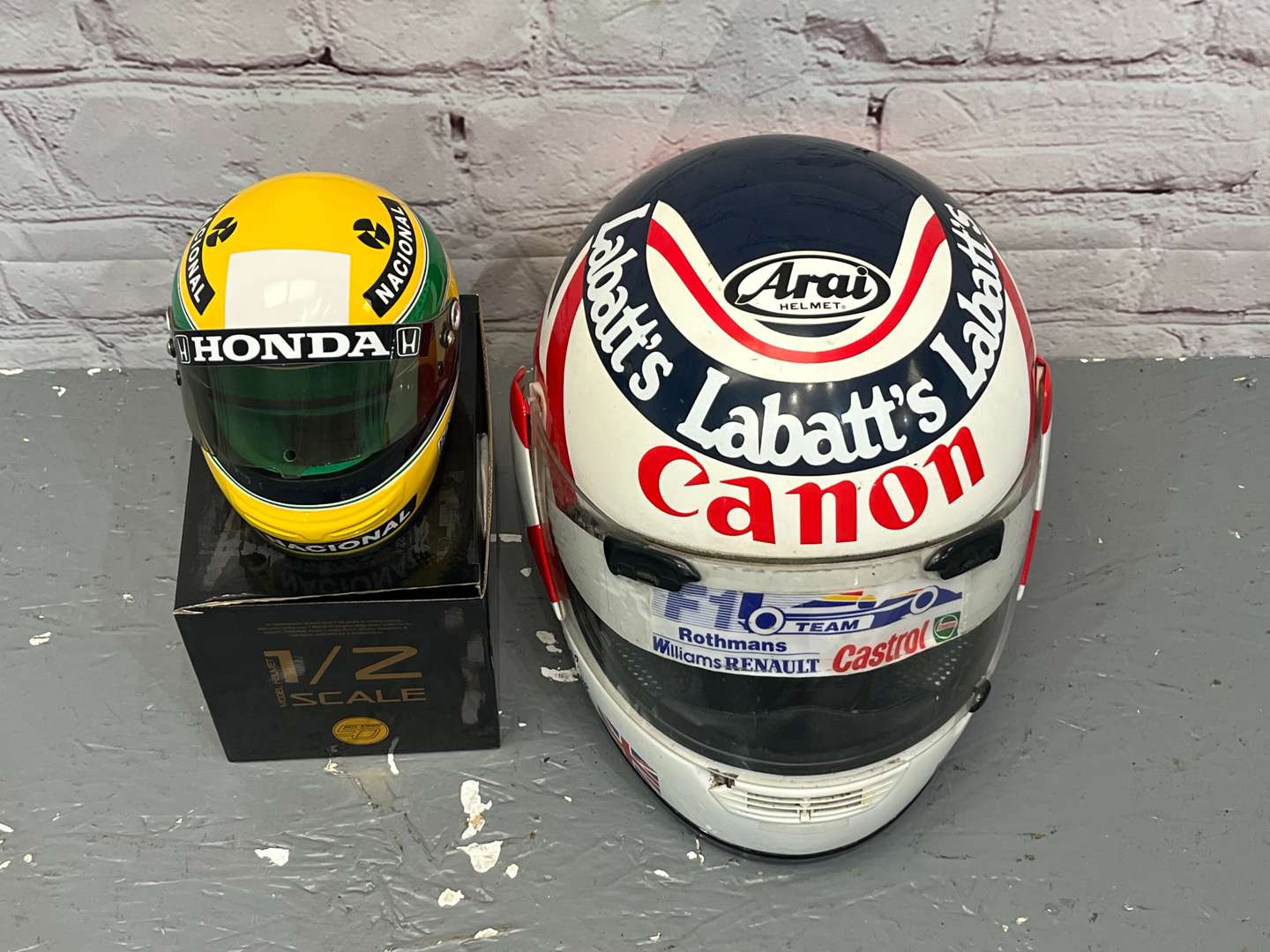 <p>Nigel Mansell & Miniature Ayrton Senna Display Helmets</p>