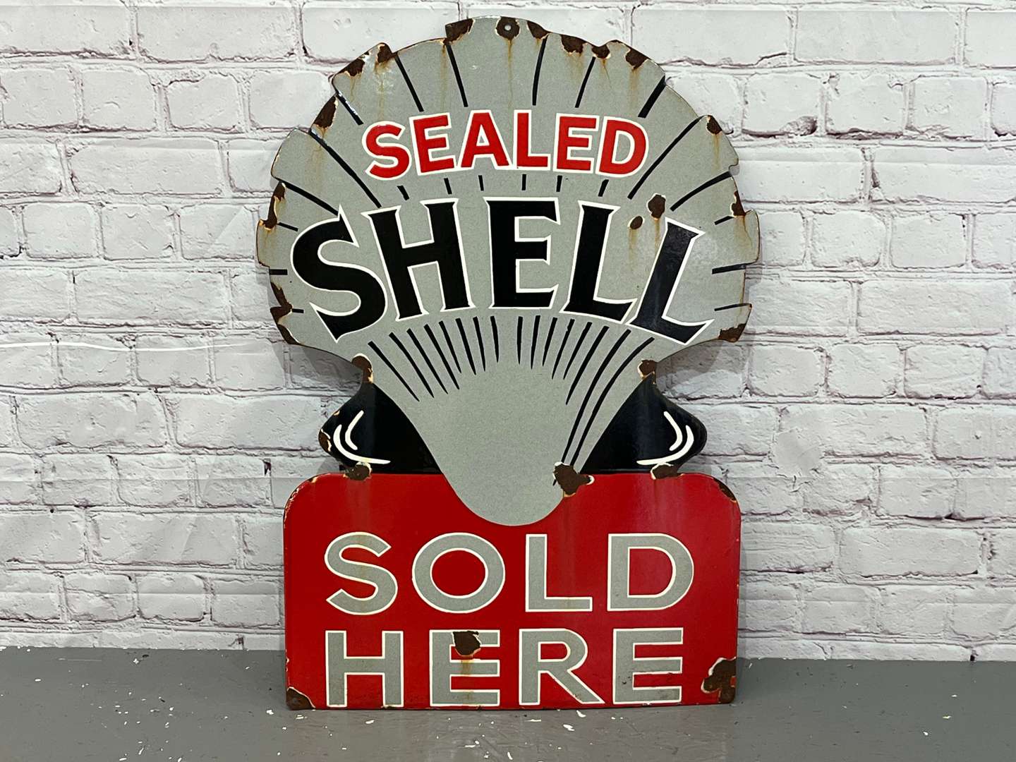 <p>Sealed Shell Sold Here Enamel Sign</p>