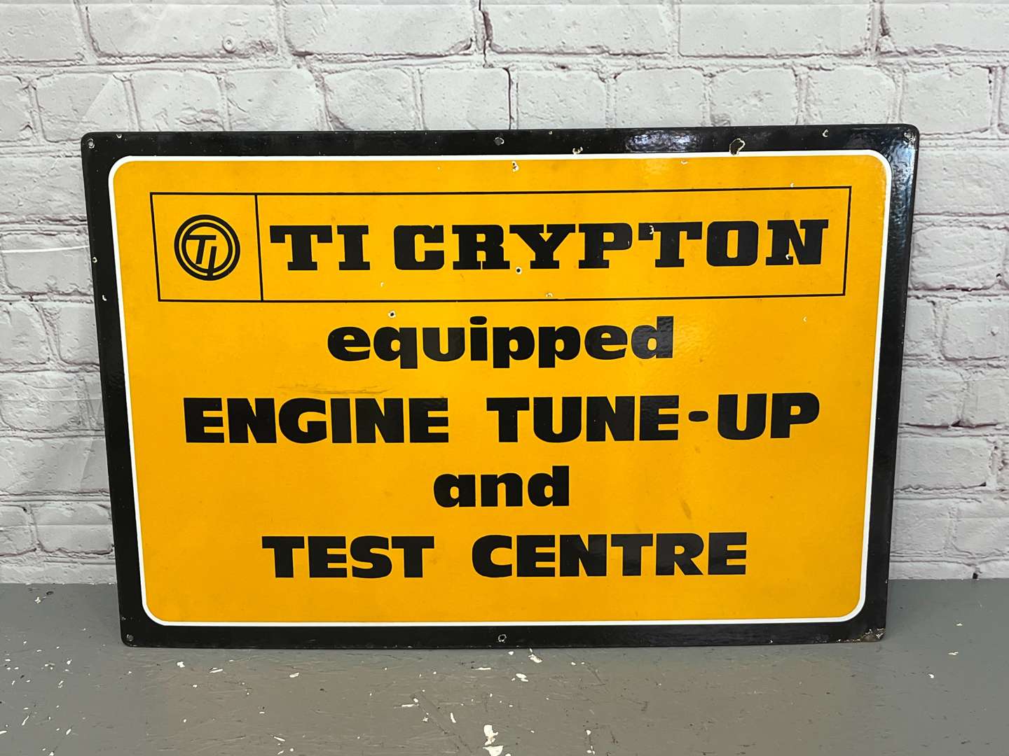 <p>Ti Crypton Engine Tune Up & Test Centre Enamel Sign</p>