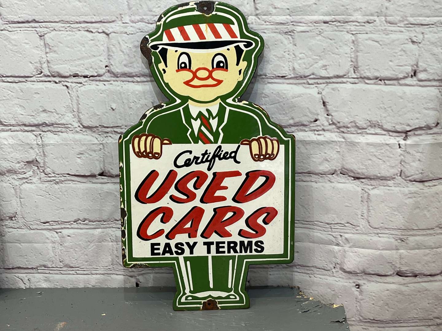 <p>Used Car Salesman Small Enamel Sign</p>
