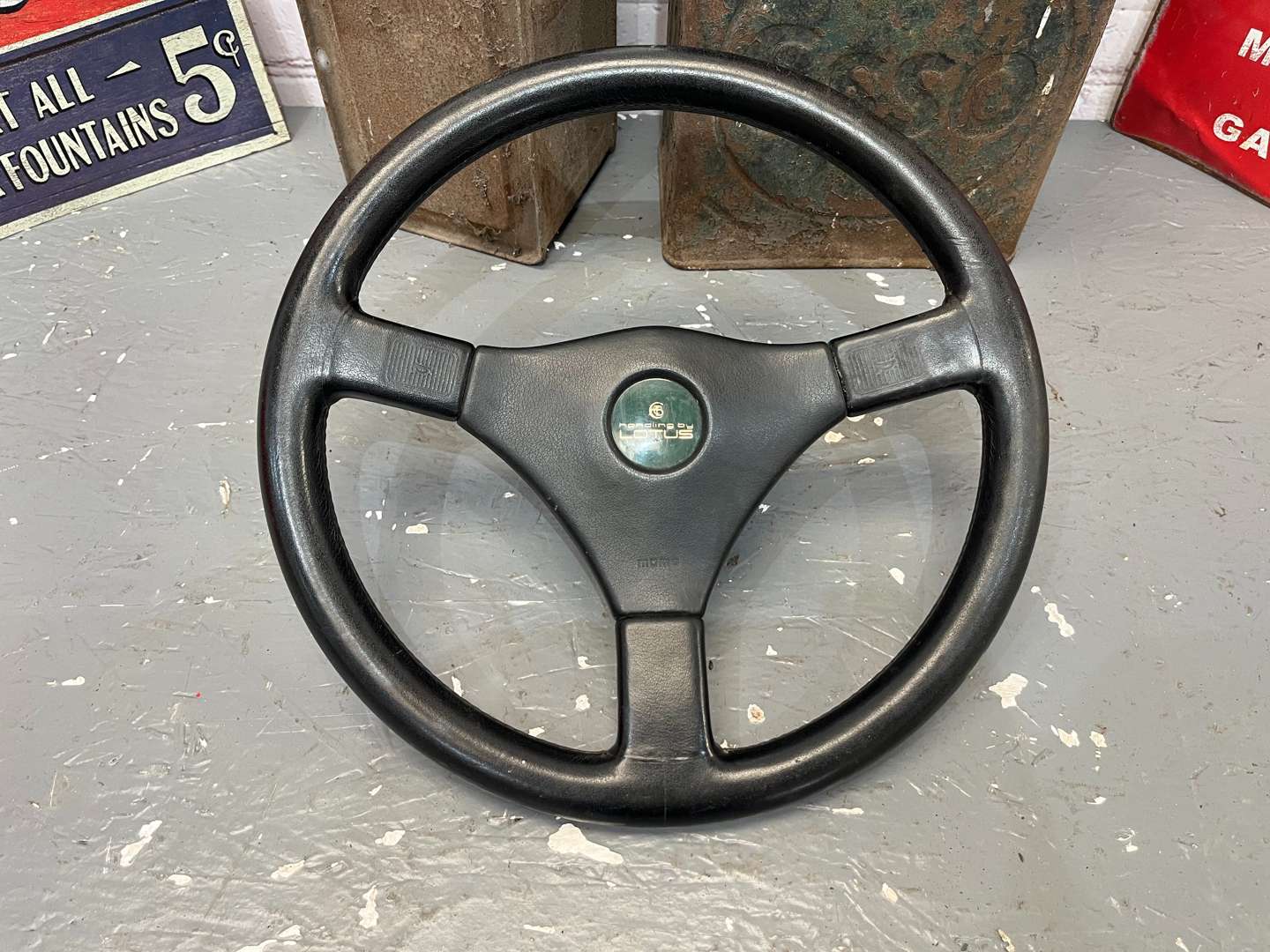 <p>Lotus Steering Wheel, Four Reproduction Tin Signs Etc</p>