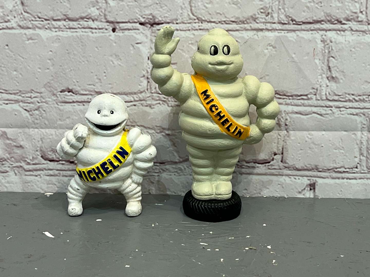 <p>Two Cast Iron Michelin Figures</p>