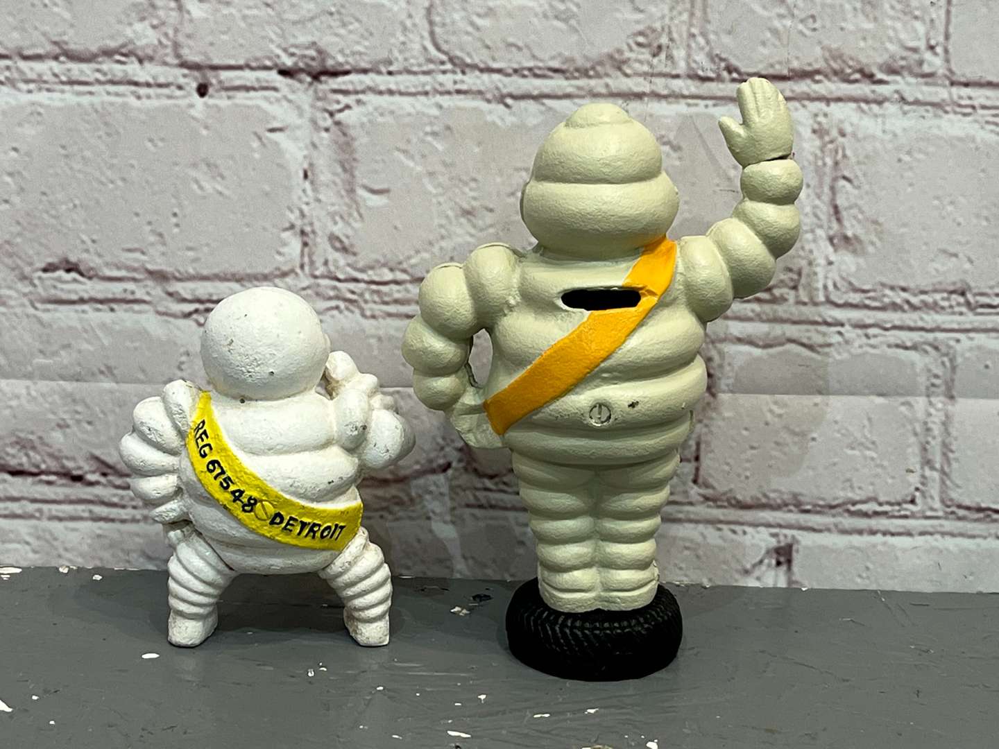 <p>Two Cast Iron Michelin Figures</p>