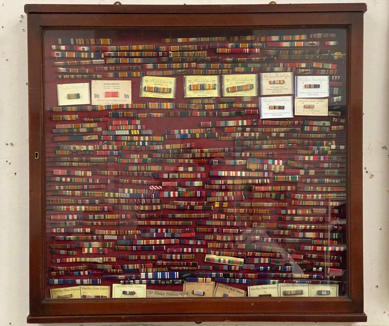 <p>GLAZED MAHOGANY DISPLAY CASE WITH MEDAL RIBBONS</p>