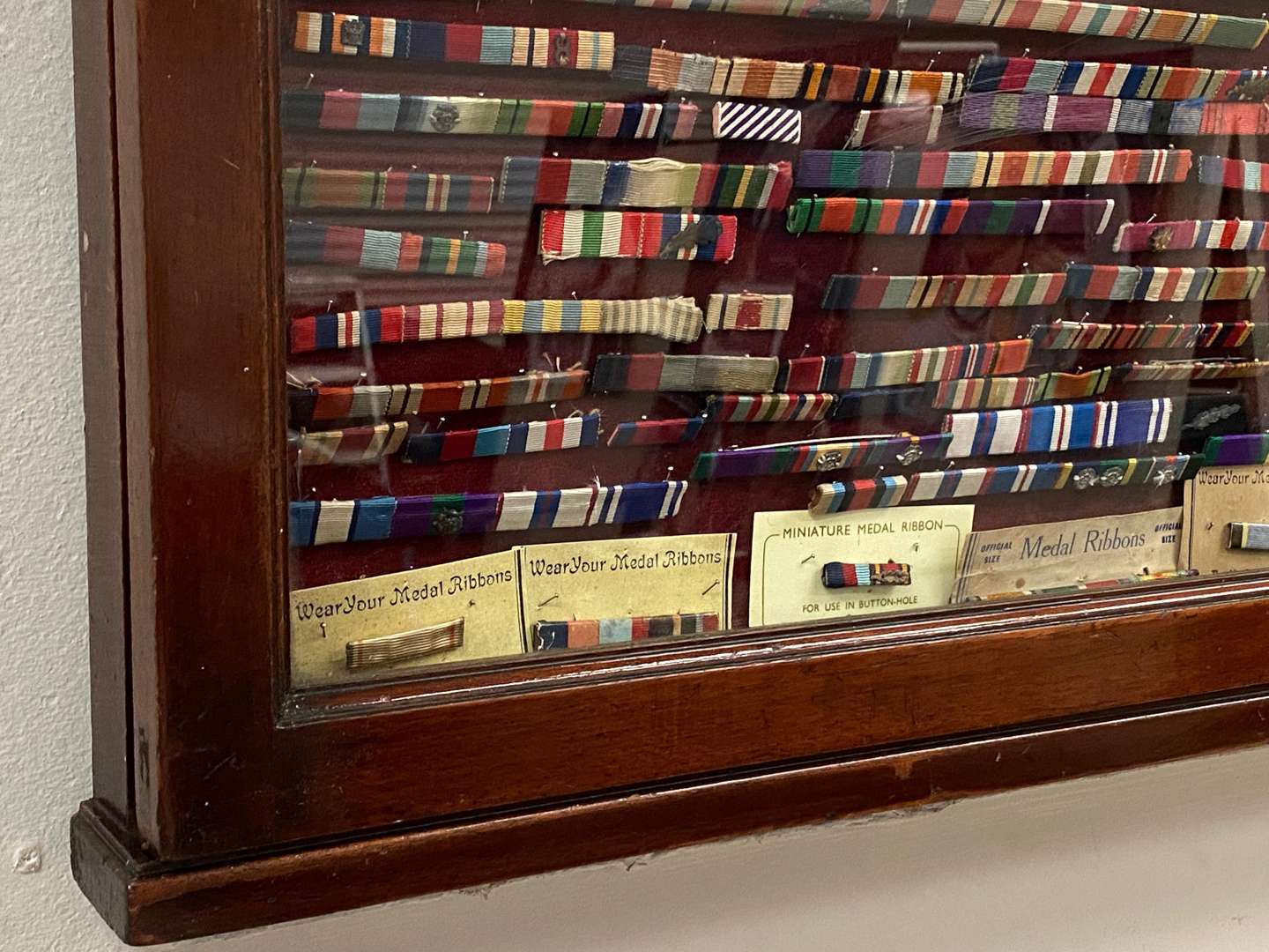 <p>GLAZED MAHOGANY DISPLAY CASE WITH MEDAL RIBBONS</p>