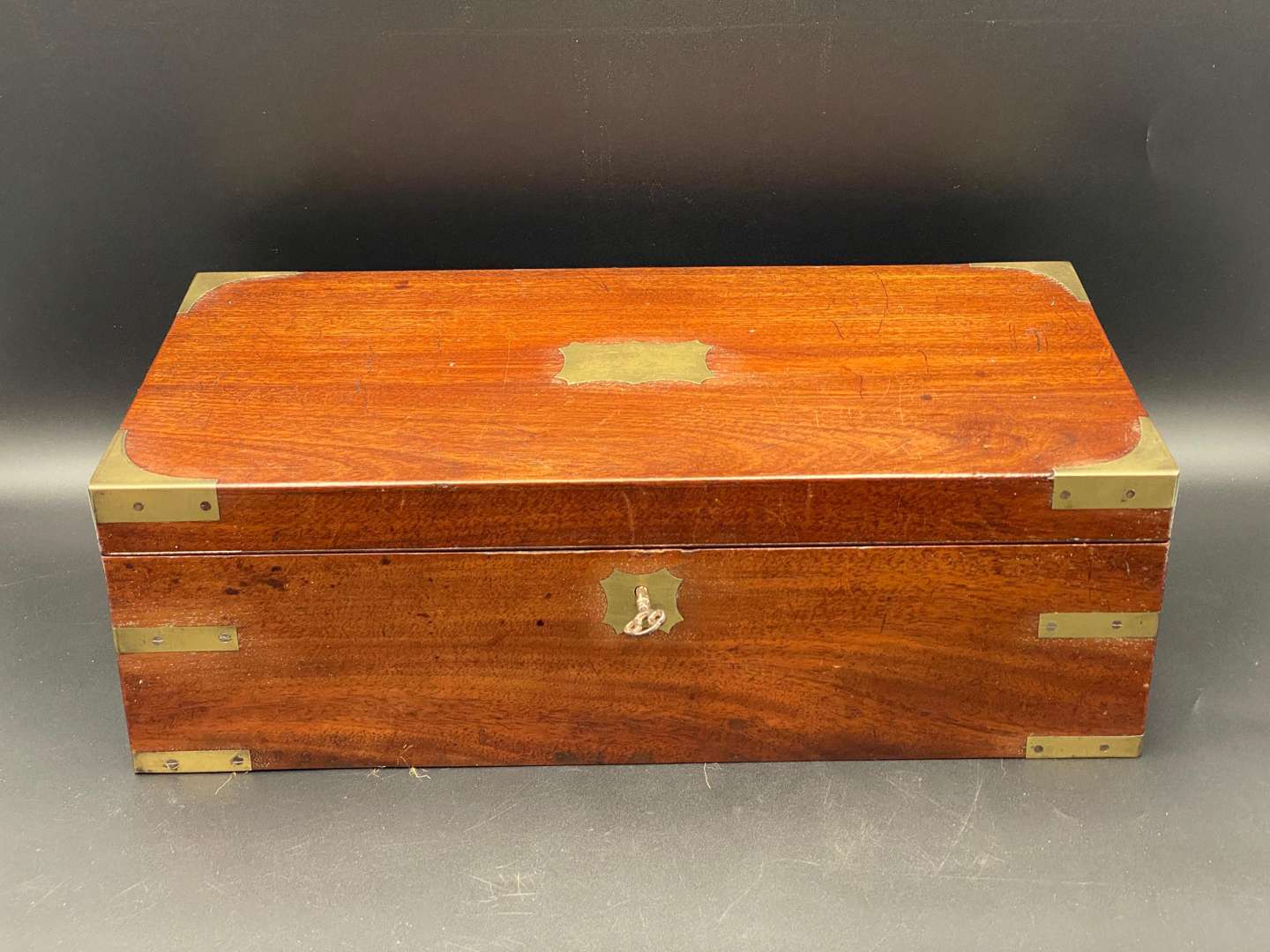 <p>MAHOGANY, BRASS BOUND WRITING SLOPE</p>