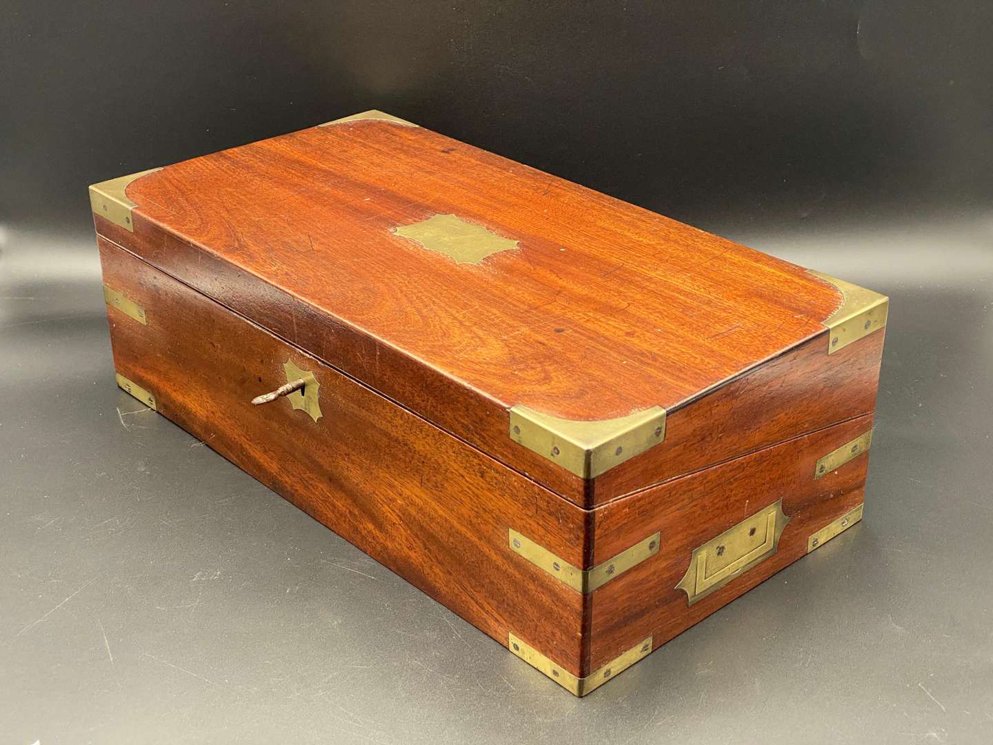 <p>MAHOGANY, BRASS BOUND WRITING SLOPE</p>