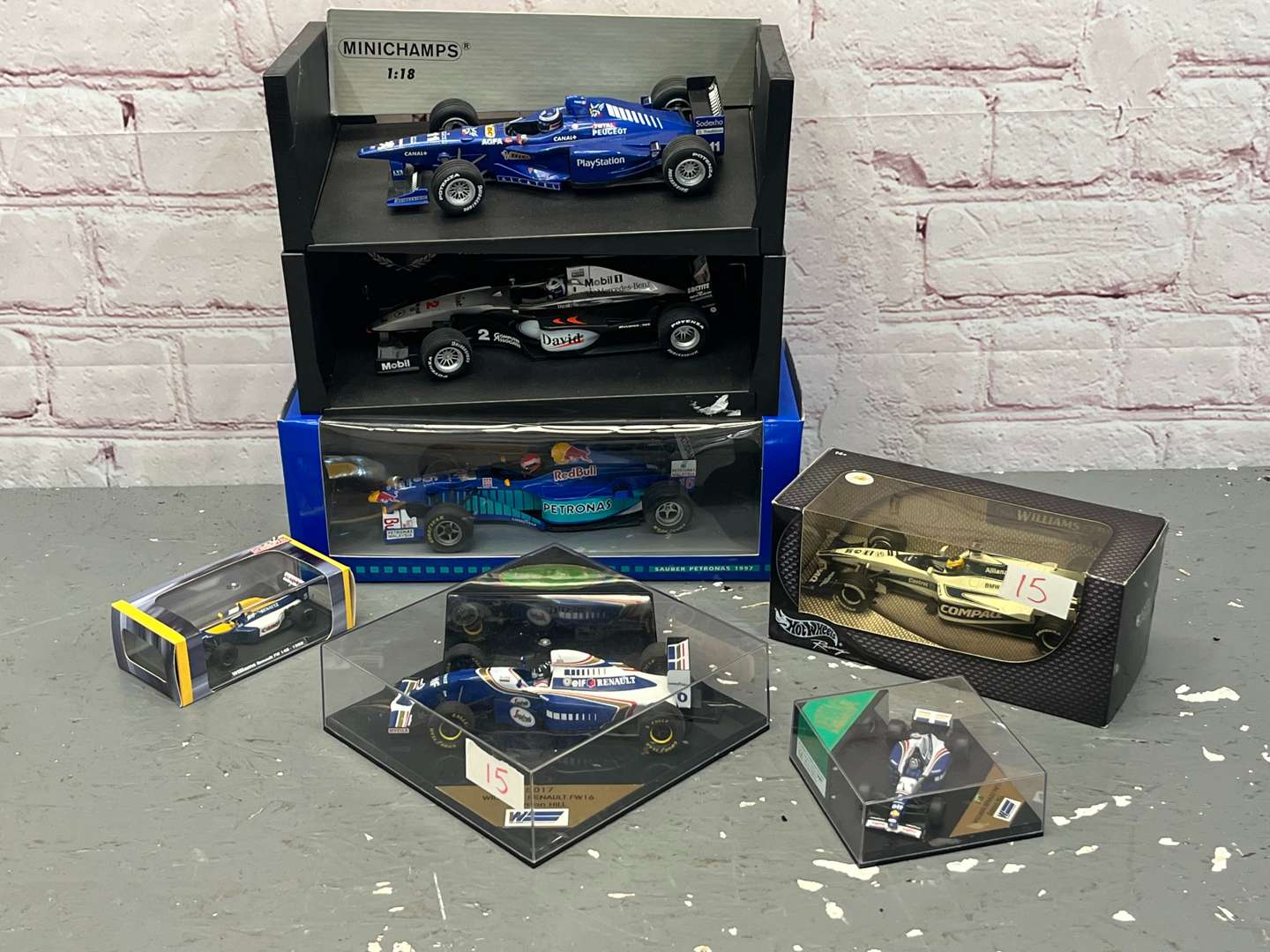 <p>Seven Boxed Formula One Model Cars</p>