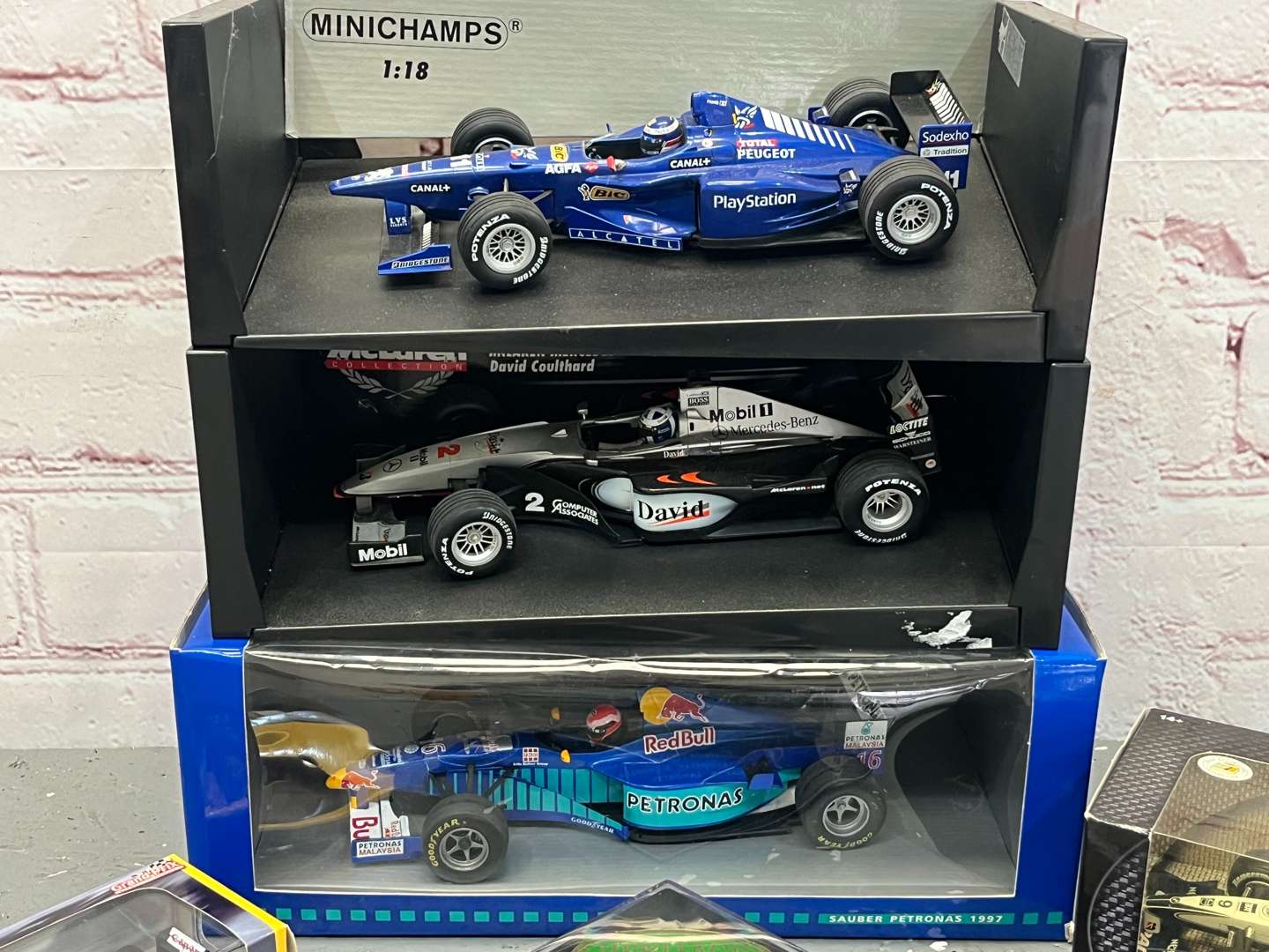 <p>Seven Boxed Formula One Model Cars</p>