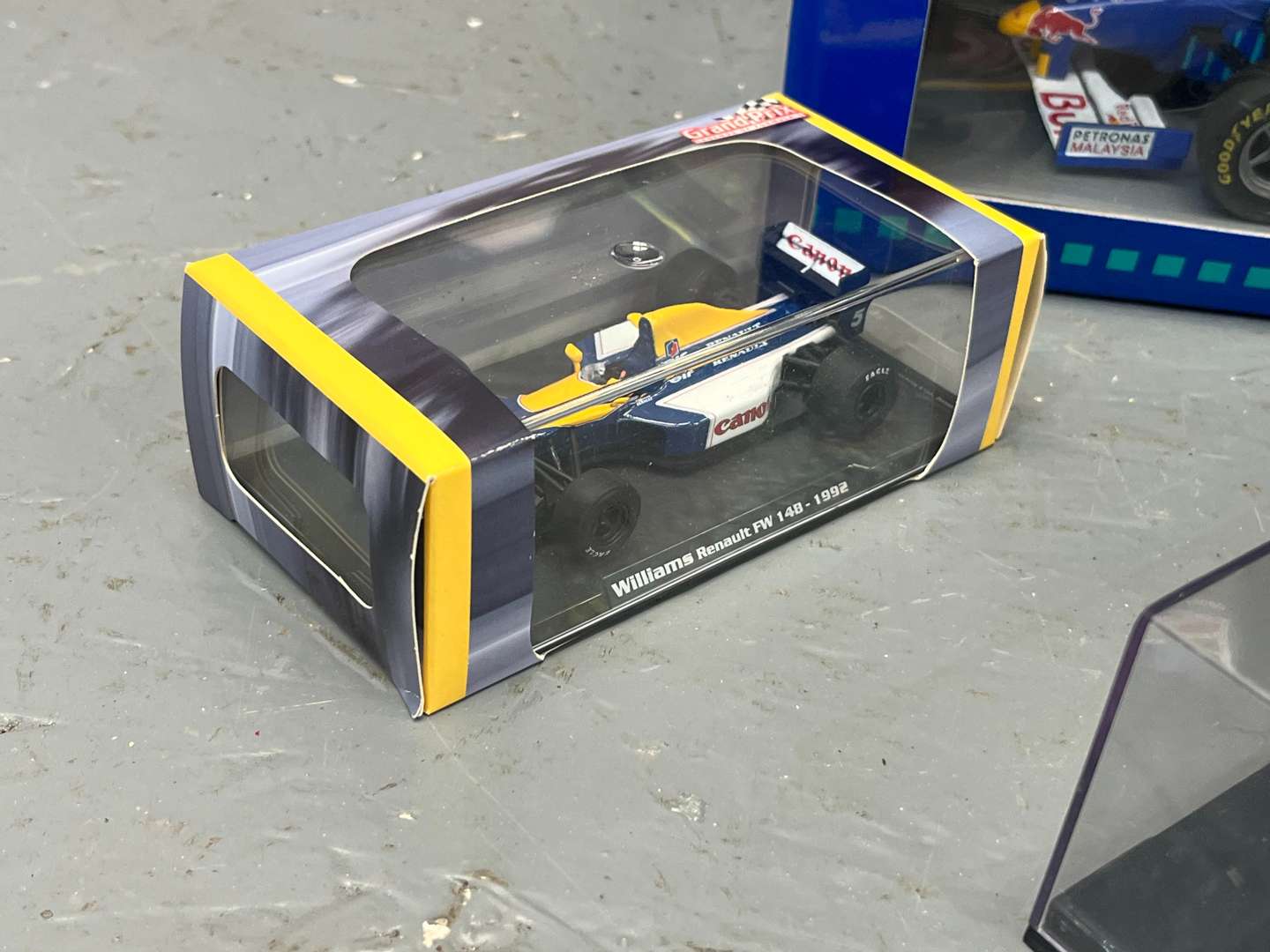 <p>Seven Boxed Formula One Model Cars</p>