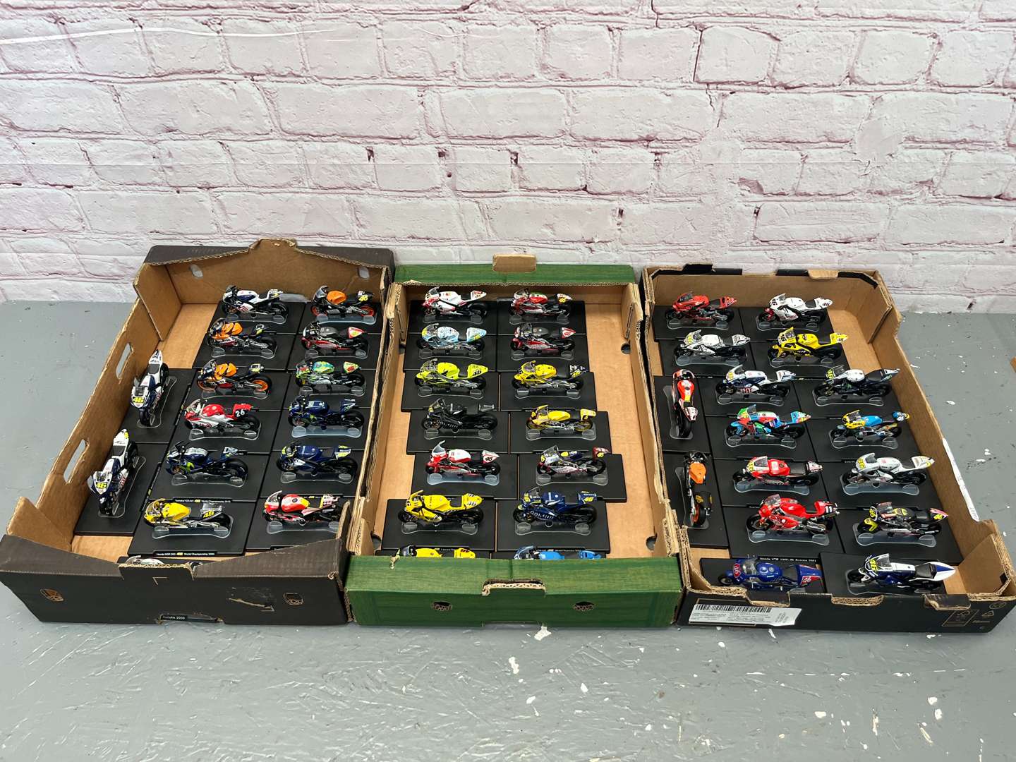 <p>Three Boxes of 46 Valentino Rossi 1:18 Scale Model Motorbikes & Magasines&nbsp;</p>