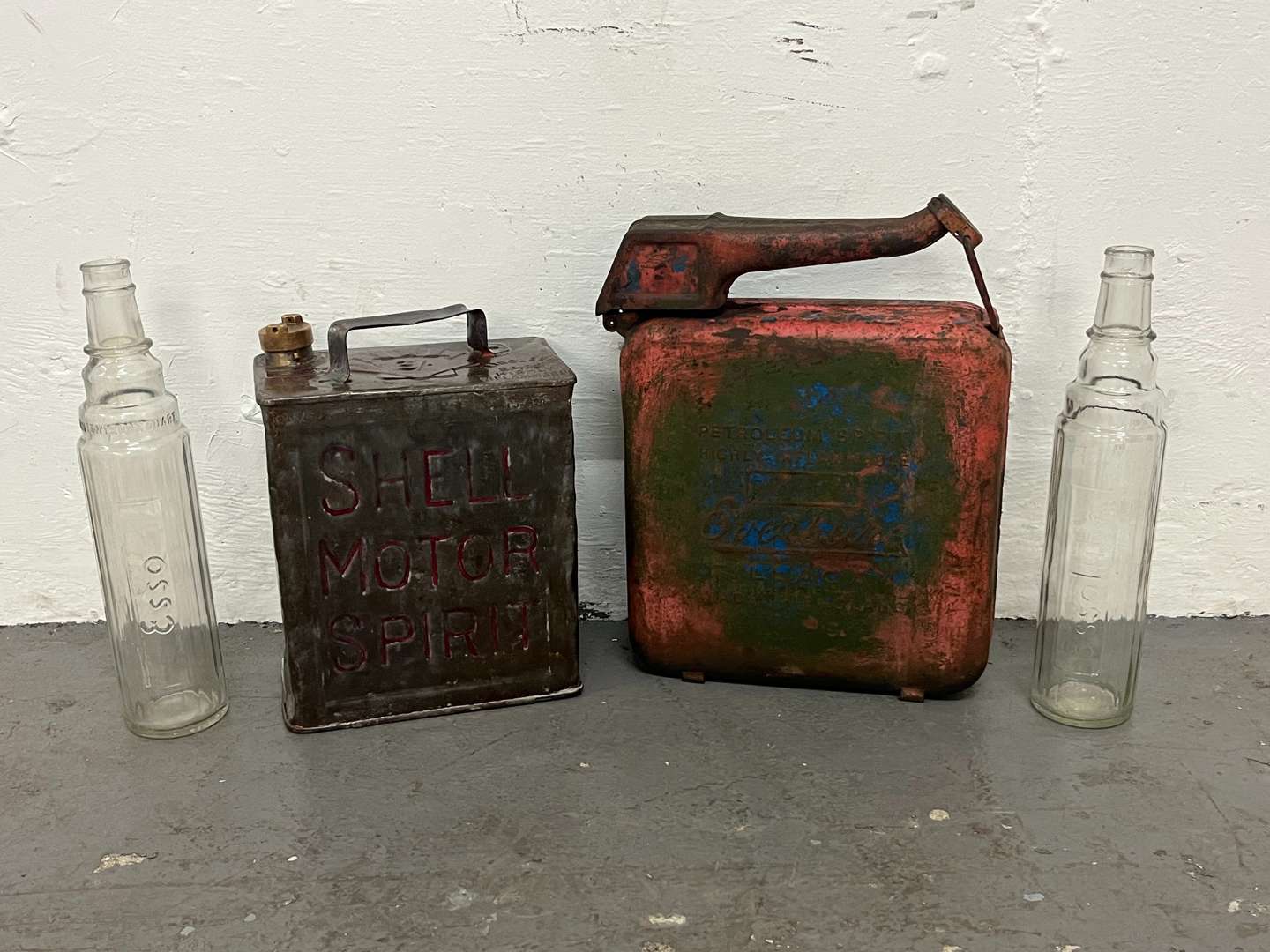 <p>Two Glass Essolube Oil Bottles, Shell Two Gallon Fuel Can & One Other (4)</p>