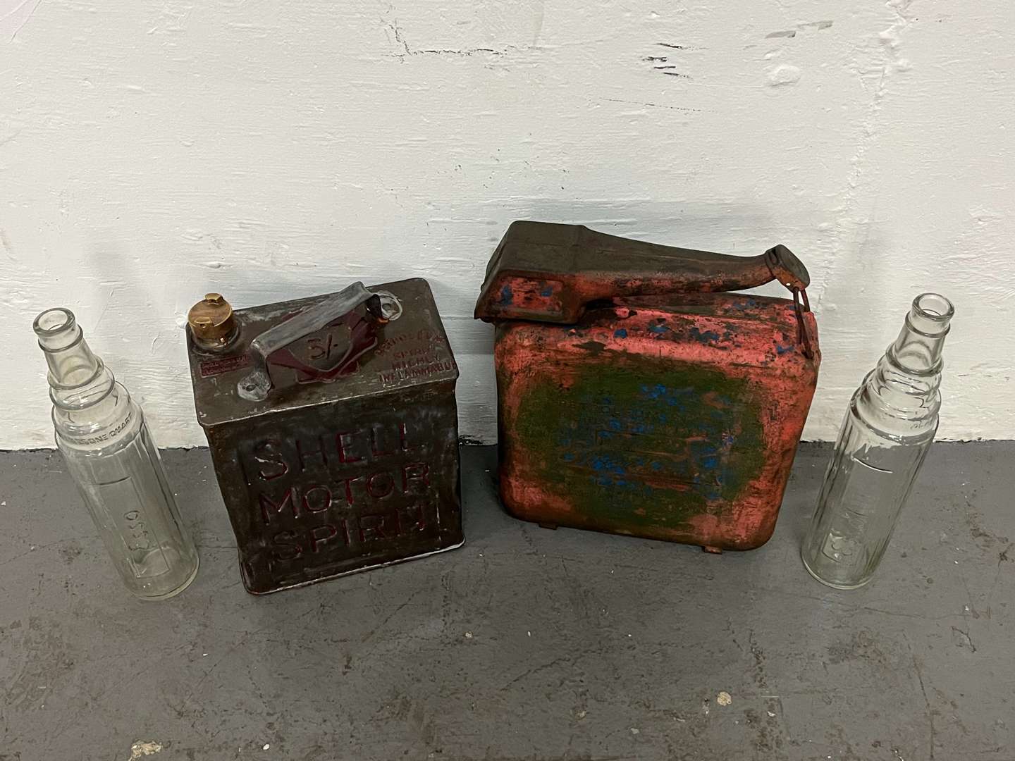 <p>Two Glass Essolube Oil Bottles, Shell Two Gallon Fuel Can & One Other (4)</p>