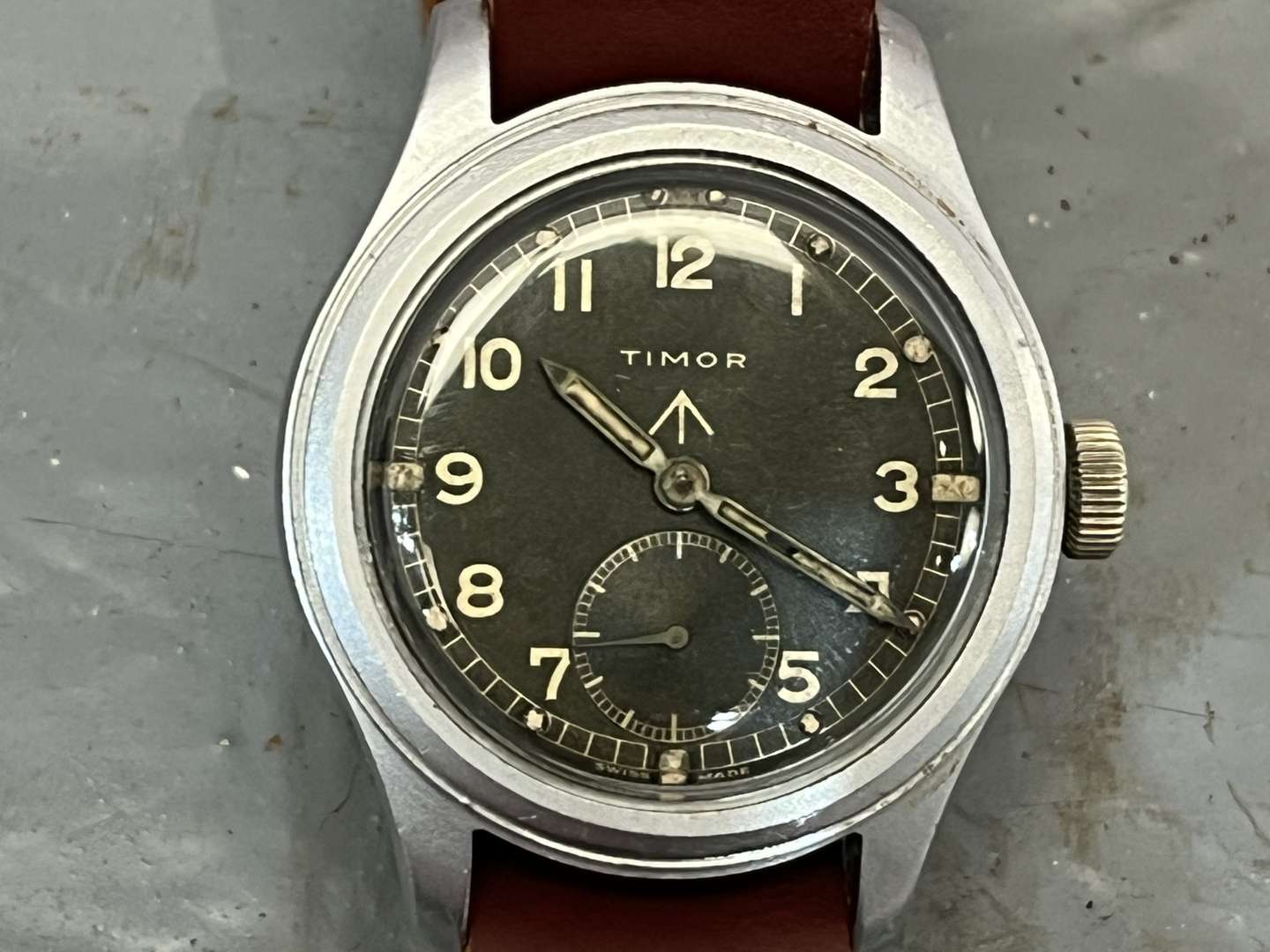 <p>Timor, WWII British Military “Dirty Dozen” Wrist Watch On a Leather Strap</p>