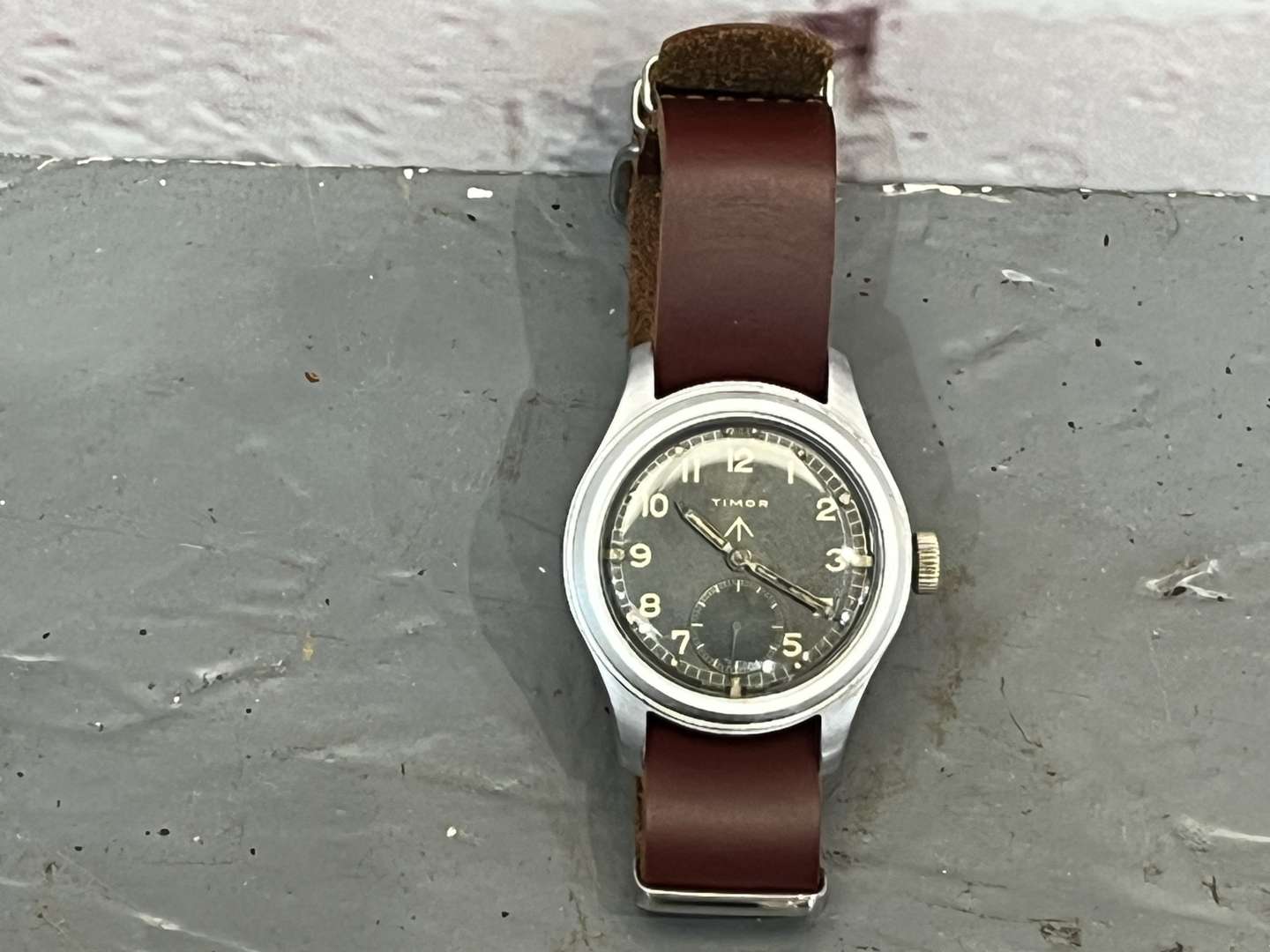 <p>Timor, WWII British Military “Dirty Dozen” Wrist Watch On a Leather Strap</p>