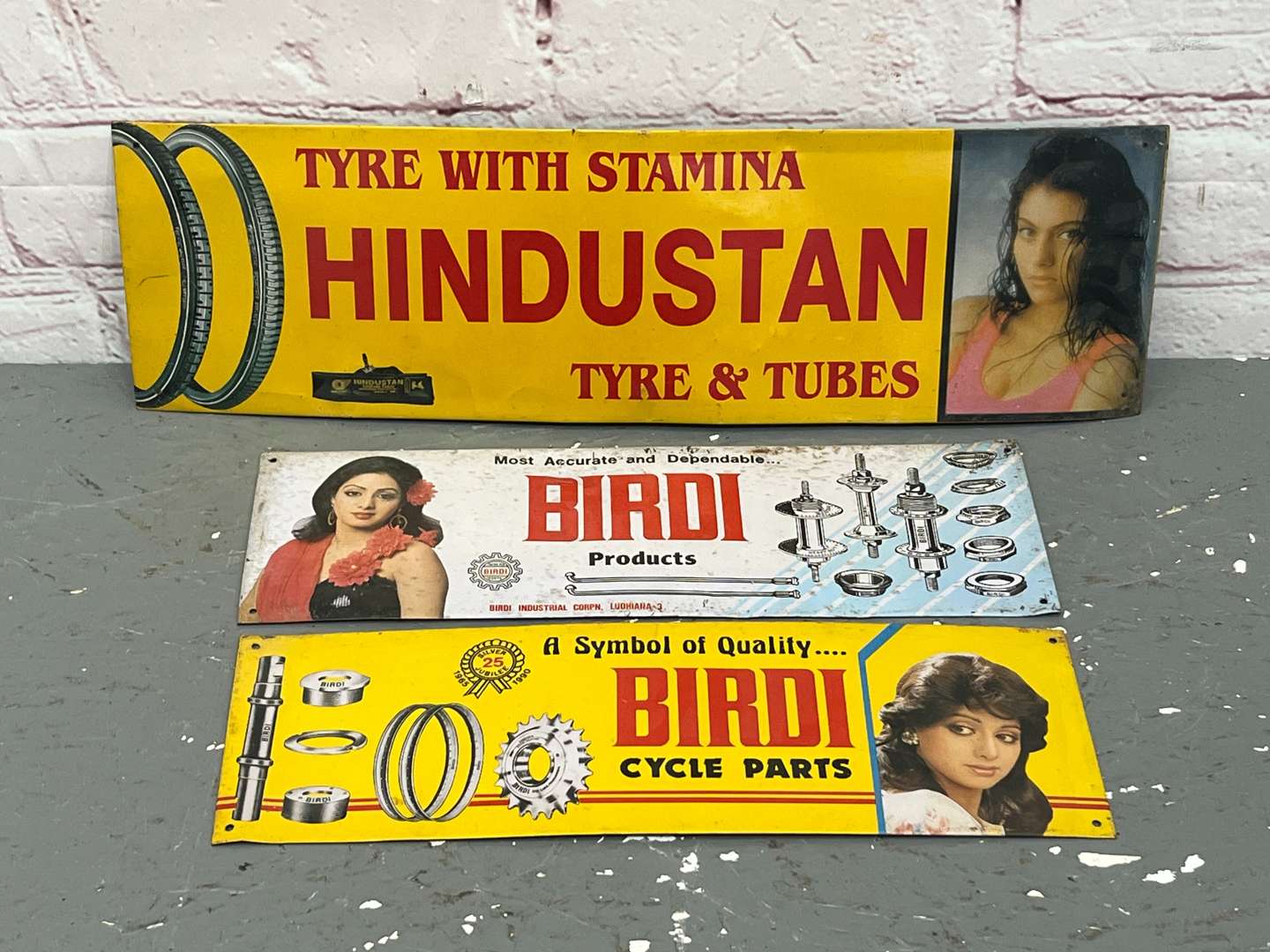 <p>Three Indian Metal Tyre and Industrial Signs</p>