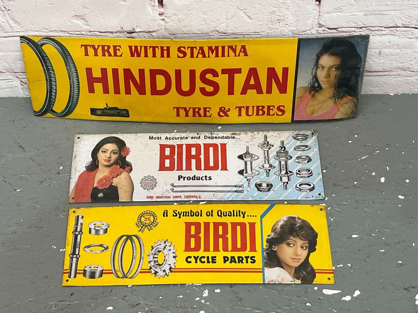 <p>Three Indian Metal Tyre and Industrial Signs</p>