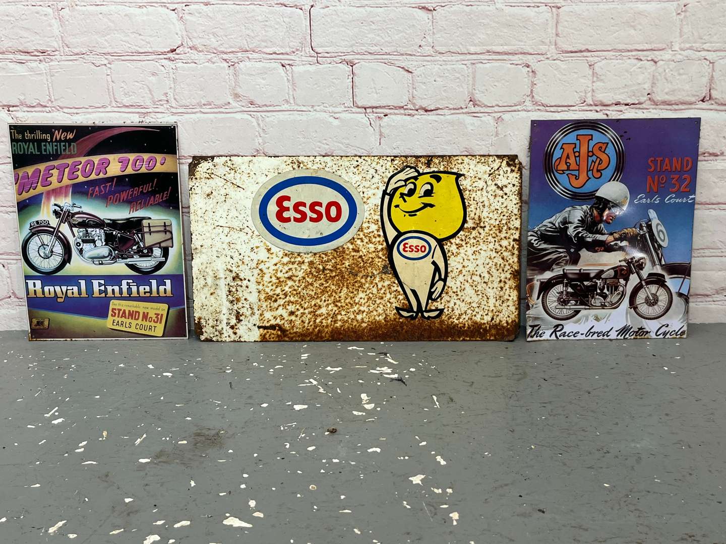 <p>Esso Mr Drip Metal Sign & AJS/Royal Enfield Tin Signs (3)&nbsp;</p>
