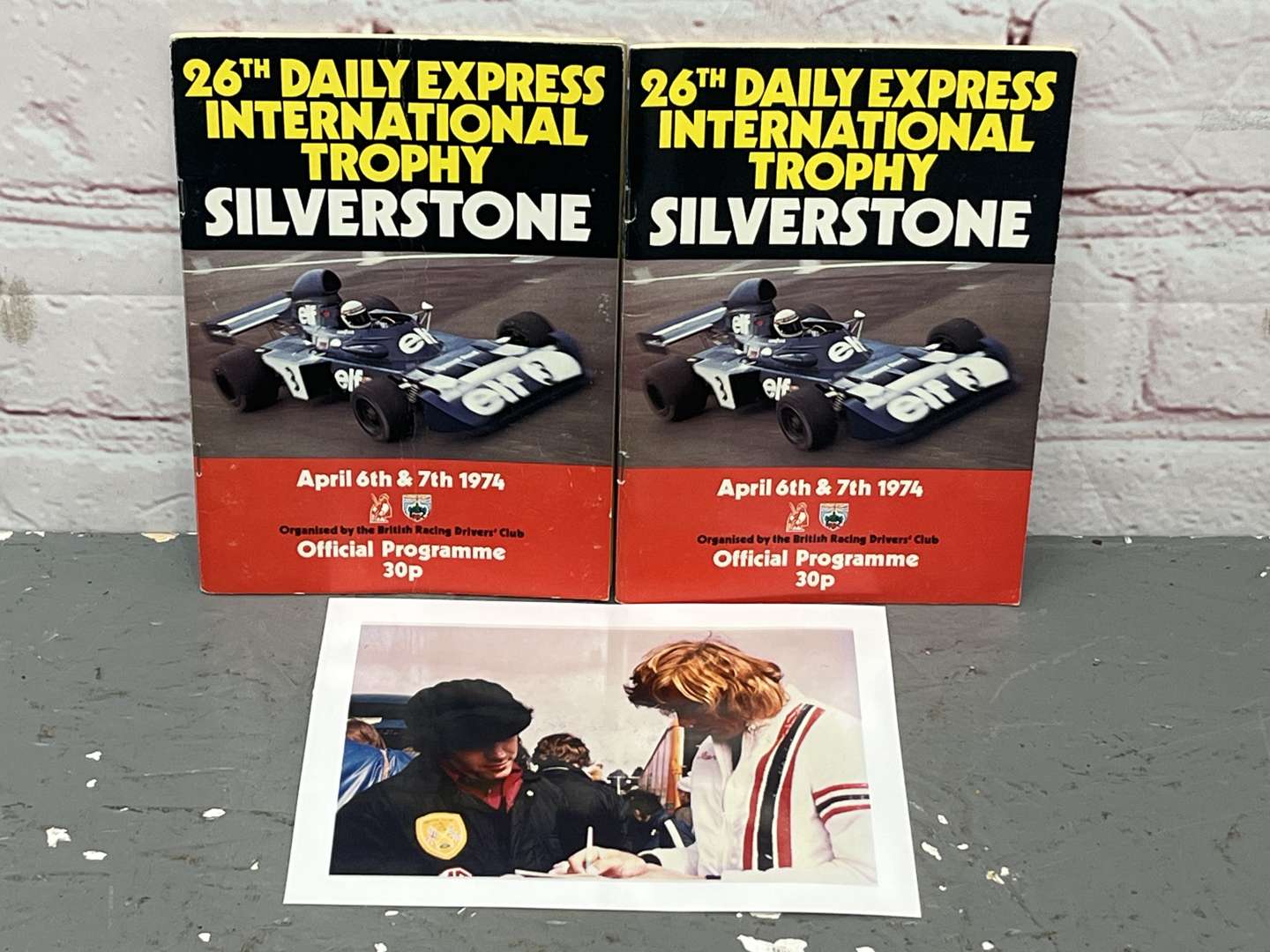 <p>1974 Silverstone James Hunt Signed Race Programme & One other With Many Signature's Including Graham Hill Etc</p>