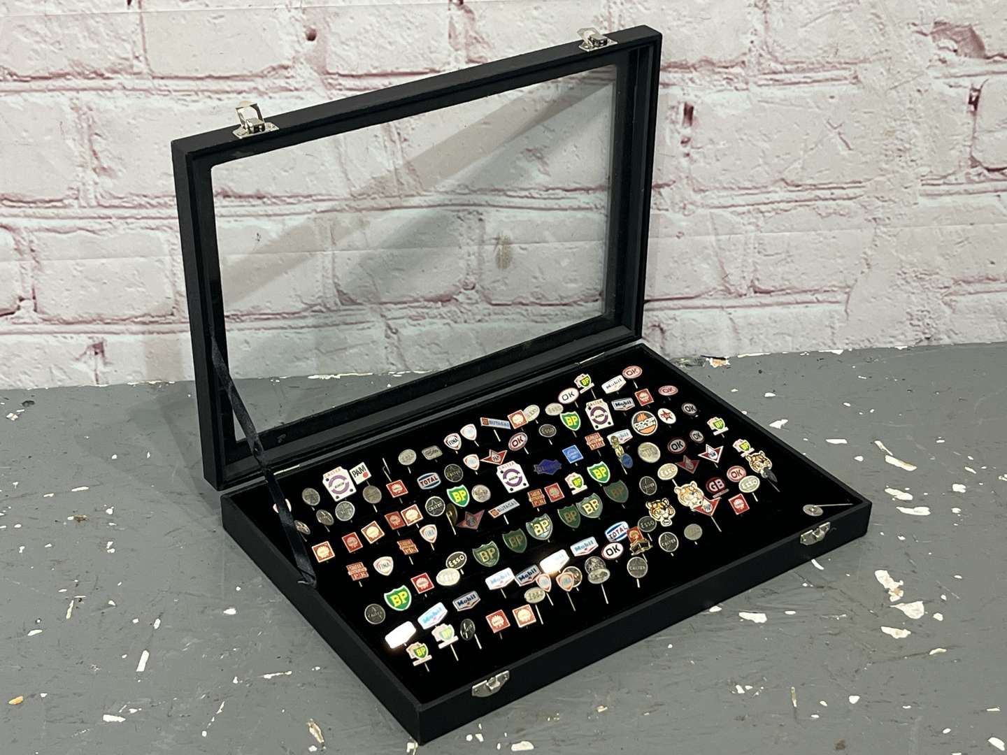 <p>Case Containing a Large Quantity Motoring Related Tie Pins&nbsp;</p>