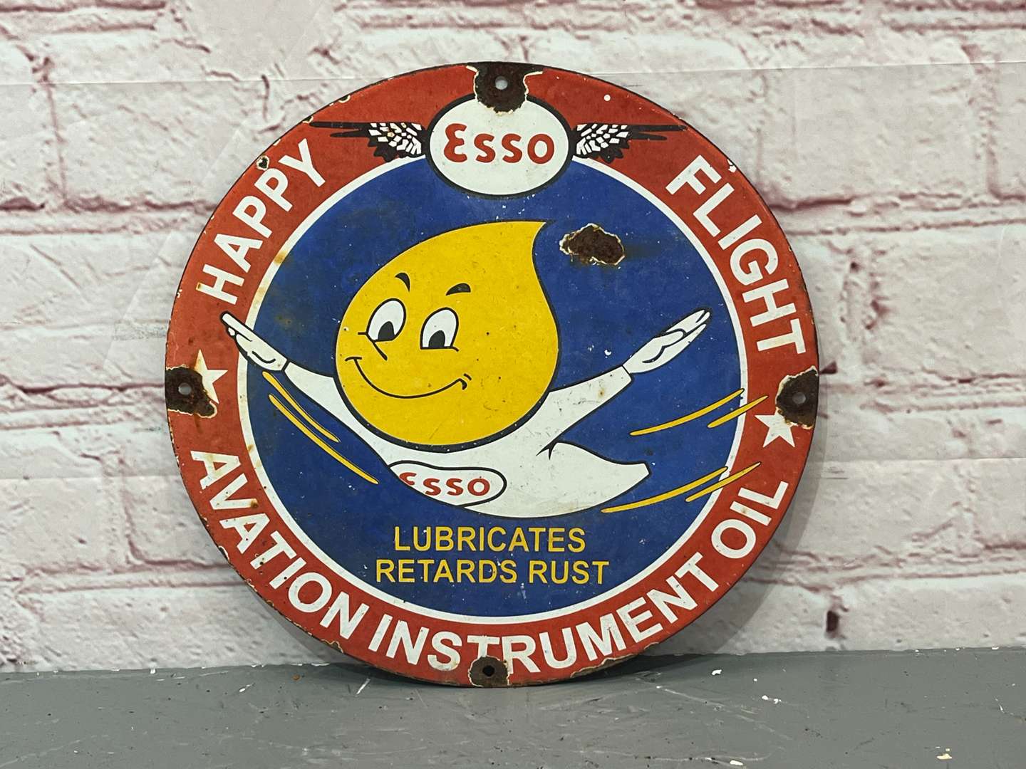 <p>Esso “Happy Motoring” Aviation Instrument Oil Small Enamel Sign</p>