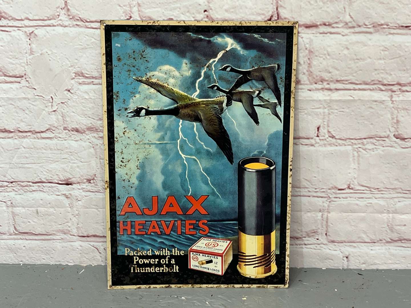 <p>Ajax Heavies Shotgun Shells Pressed Tin Sign</p>
