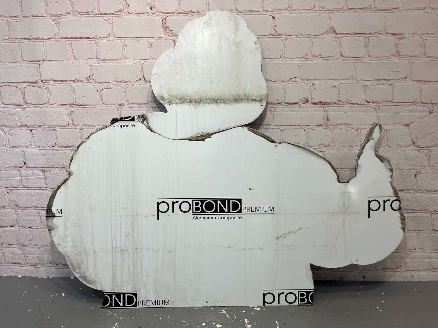 <p>Large Michelin Man, Thumbs Up On Metal Board Sign</p>