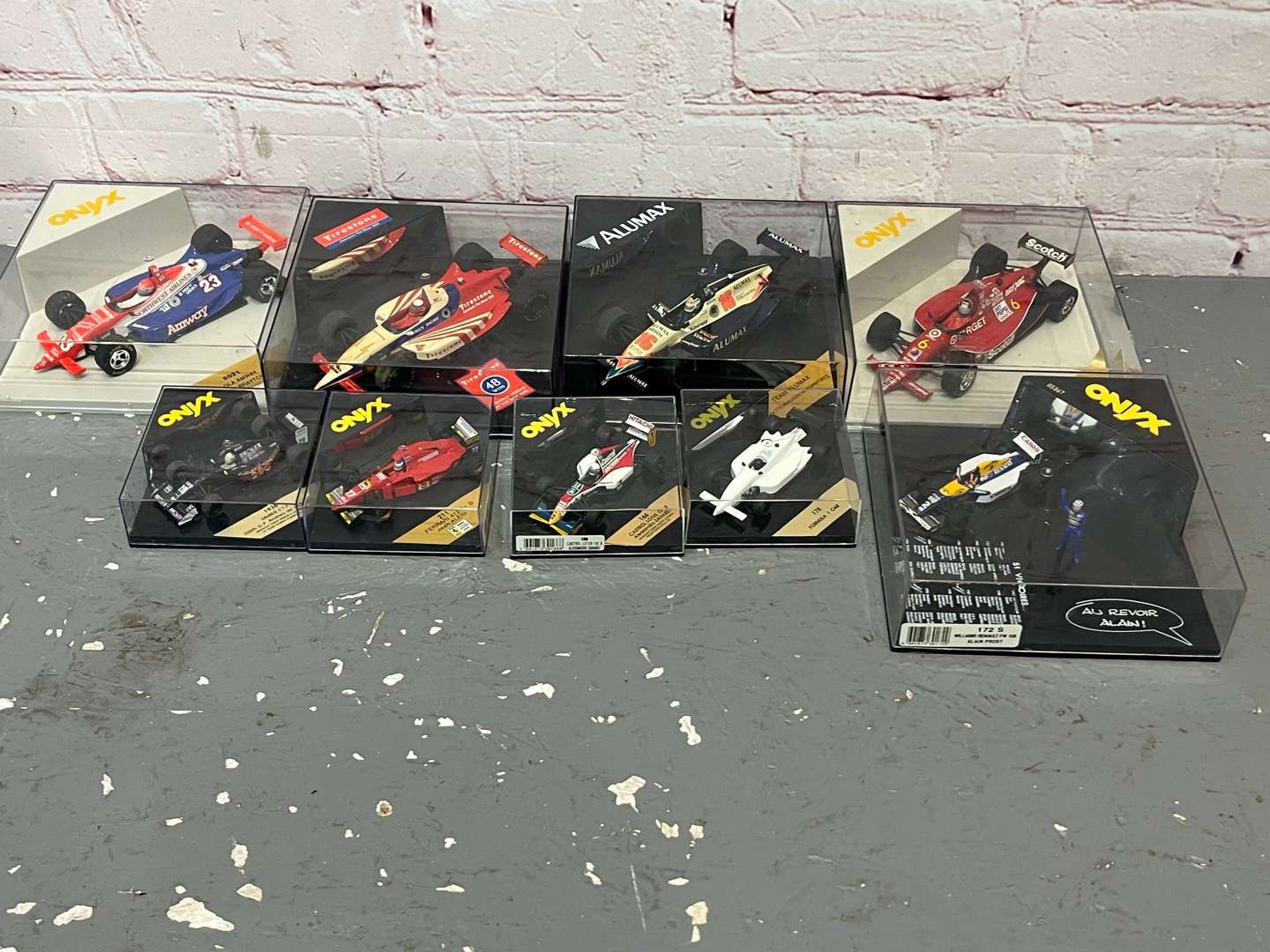 <p>Nine Cased Formula One Model Cars</p>