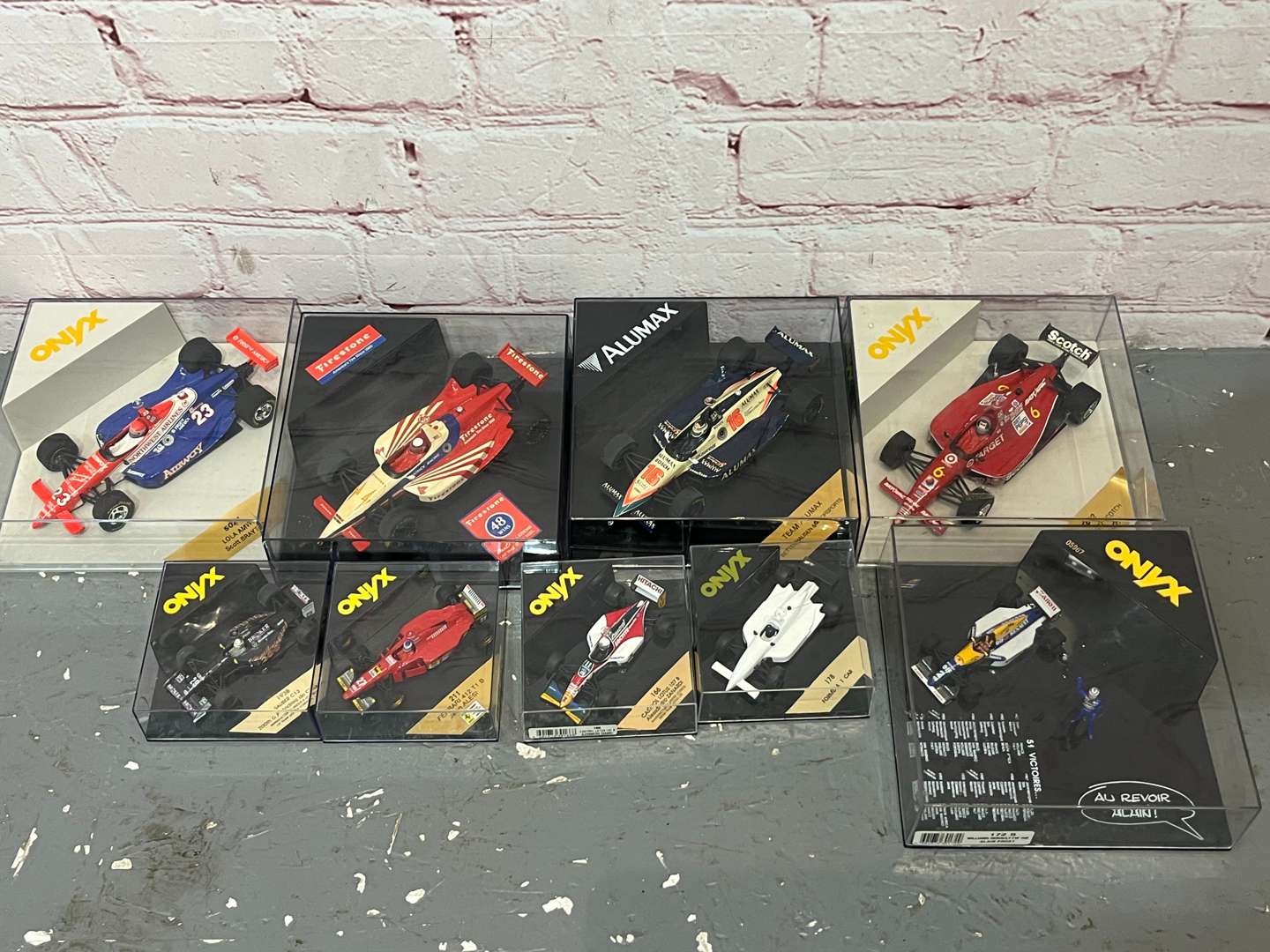<p>Nine Cased Formula One Model Cars</p>